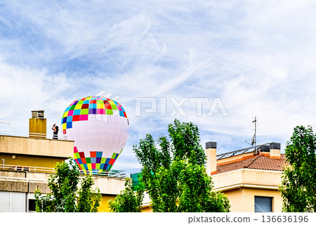Colorful hot air balloon flying over blue sky with white clouds Colorful hot air balloon flying over blue sky with white clouds 136636196