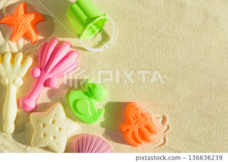 Colorful Beach Toys and Molds on Sand. Summer Fun and Outdoor Play FlatLay Colorful Beach Toys and Molds on Sand. Summer Fun and Outdoor Play FlatLay 136636239