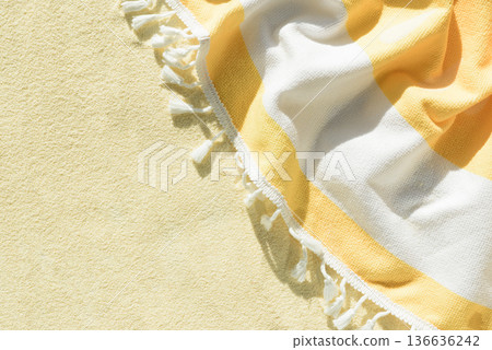 Yellow Beach Towel with Striped Fabric and Tassels. Summer Vacation Flatlay Yellow Beach Towel with Striped Fabric and Tassels. Summer Vacation Flatlay 136636242