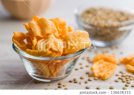 Crispy lentil chips on kitchen table. Crispy lentil chips on kitchen table. 136636355