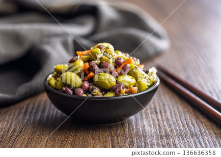 Fresh salad with edamame beans in bowl on wooden table. 136636358