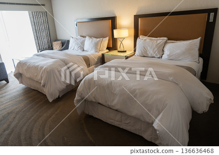 Hotel room with cozy bed in bedroom. Home design. Furniture for bedroom. Interior design in apartment. Comfortable bed in hotel bedroom. Bedding and accommodation Hotel room with cozy bed in bedroom. Home design. Furniture for bedroom. Interior design in apartment. Comfortable bed in hotel bedroom. Bedding and accommodation 136636468