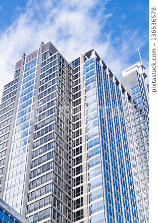 Business city. City architecture. Modern glass building. Reflective glass architecture. Architecture business district. Building architecture. Business building. Glass building. Urban business core Business city. City architecture. Modern glass building. Reflective glass architecture. Architecture business district. Building architecture. Business building. Glass building. Urban business core 136636578