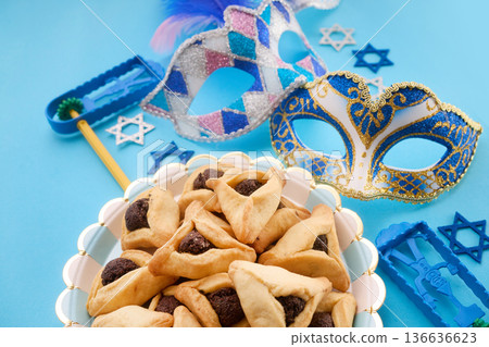 Purim celebration with festive masks and hamantaschen cookies Purim celebration with festive masks and hamantaschen cookies 136636623
