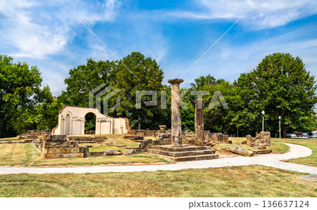 Old Alabama State Capitol ruins in Tuscaloosa. Historic site features stone columns and foundation remains in Capitol Park under a blue sky 136637124