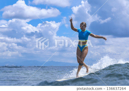 Woman Sharpens Her Longboard Talents Beneath Clear Skies And Remote Islands Woman Sharpens Her Longboard Talents Beneath Clear Skies And Remote Islands 136637264
