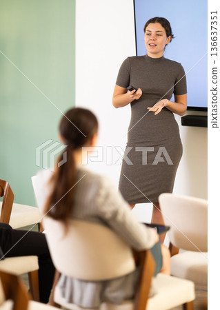 young woman giving a speech to a team of specialists 136637351