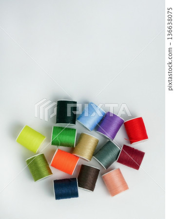 Bright multicolor thread spools on white background. Sewing, tailoring and DIY craft concept with copy space. High resolution image Bright multicolor thread spools on white background. Sewing, tailoring and DIY craft concept with copy space. High resolution image 136638075