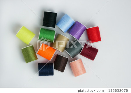 Bright multicolor thread spools on white background. Sewing, tailoring and DIY craft concept with copy space. High resolution image 136638076