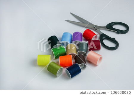 Colorful sewing thread spools with scissors on white background. Tailoring, DIY craft and handmade concept. Studio shot with copy space, high resolution detail Colorful sewing thread spools with scissors on white background. Tailoring, DIY craft and handmade concept. Studio shot with copy space, high resolution detail 136638080