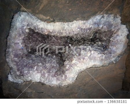 Close-up of a light purple amethyst geode embedded in basalt rock. Vanda mines in Misiones Province, Argentina 136638181