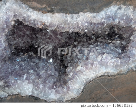 Beautiful amethyst crystal geode displaying vibrant purple quartz formations with natural crystalline facets. Stunning geological specimens that showcase complex mineral structures and natural beauty. 136638182