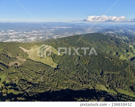 Scenic Mountain Ridge With City View, Expansive Mountain Range Overlooking Urban And Natural Scenery 136638432