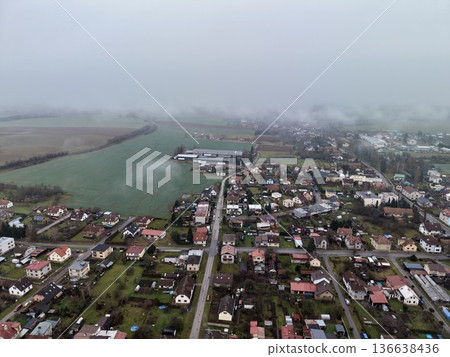 Serene Lakeside Village With Fields, Calm Morning Environment Featuring Scattered Homes And Water 136638436