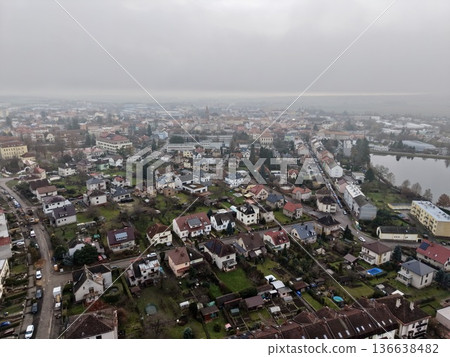 Overcast Aerial Shot Of Neighborhood, Cloudy Drone Image Showcasing Lakeside Homes And Winding Streets Overcast Aerial Shot Of Neighborhood, Cloudy Drone Image Showcasing Lakeside Homes And Winding Streets 136638482