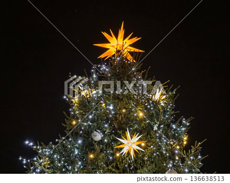 Festive Tree Illumination, Illuminated Christmas Tree Topped By Glowing Star And Colorful Decorations 136638513