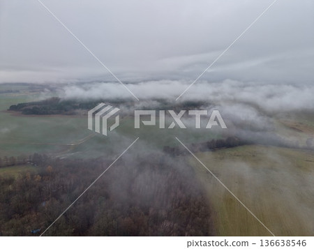 Drone Captures Cloudy Forest Scene Mood, Atmospheric Image Of Fog Drifting Over Treetops From Above Drone Captures Cloudy Forest Scene Mood, Atmospheric Image Of Fog Drifting Over Treetops From Above 136638546