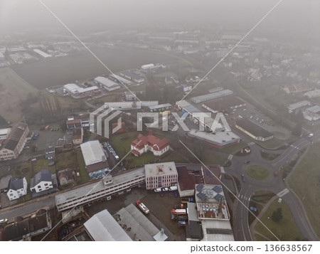 Quiet Urban Area Shrouded In Morning Mist, Small Town With Dense Rooftops Obscured By Fog And Mist Quiet Urban Area Shrouded In Morning Mist, Small Town With Dense Rooftops Obscured By Fog And Mist 136638567