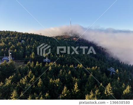 Antenna Arrays And Access Roads Showcase Vital Connectivity Infrastructure On Misty Mountain Top 136638580