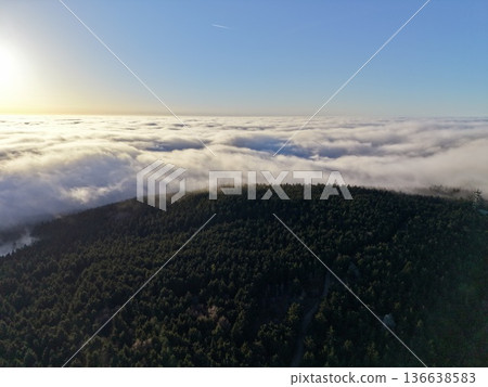 Morning Glow Over Mountain Landscape, Golden Clouds Drift Above Lush Forested Hills During Dawn Morning Glow Over Mountain Landscape, Golden Clouds Drift Above Lush Forested Hills During Dawn 136638583