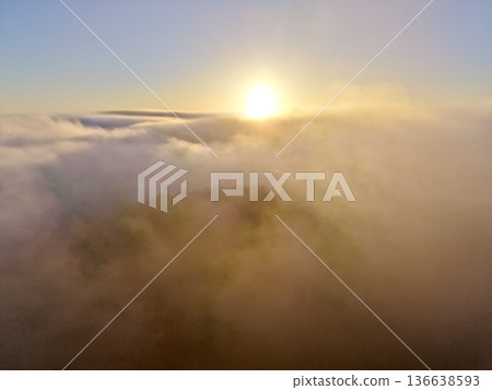 Sun Rises Quietly, Golden Rays Of Sunlight Break Through Morning Mist Creating Dramatic Sky Outlines Sun Rises Quietly, Golden Rays Of Sunlight Break Through Morning Mist Creating Dramatic Sky Outlines 136638593