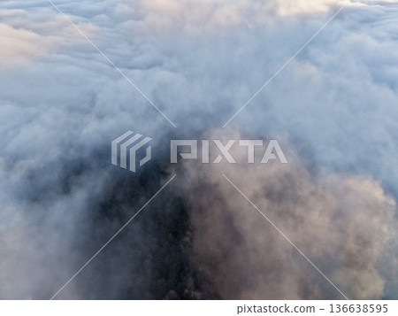 Rugged Mountain Peaks Cut Through Thick Early Morning Fog Revealing Mysterious Wooded Valleys Underneath Rugged Mountain Peaks Cut Through Thick Early Morning Fog Revealing Mysterious Wooded Valleys Underneath 136638595
