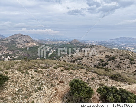 Mountains Overlook Tranquil Seaside Village, Hilly Landscape With Calming Ocean And Distant Islands 136638606