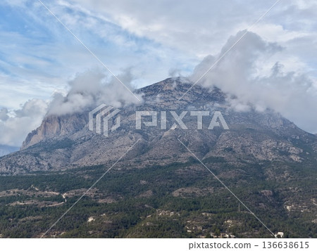 Misty Mountain Top Overlooking Village And Woods, Summit Shrouded In Mist With Scenic Hamlet Nearby Misty Mountain Top Overlooking Village And Woods, Summit Shrouded In Mist With Scenic Hamlet Nearby 136638615