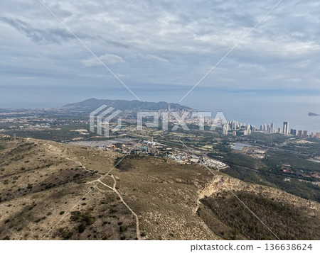 Hillside Skyline With Rugged Landscape, Seaside Cityscape Featuring Winding Roads And Cloudy Sky Hillside Skyline With Rugged Landscape, Seaside Cityscape Featuring Winding Roads And Cloudy Sky 136638624
