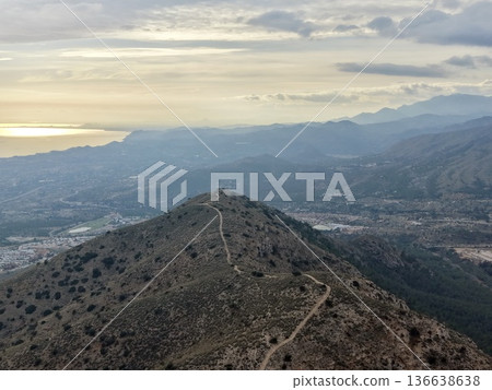 Sunset Hill Silhouette, Golden Glow Over Distant Shore, Dramatic Coast Horizon With Soft Sunset Glow 136638638