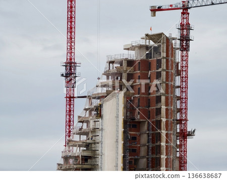 Morning Becomes Concrete And Steel, Industrial Area Awakens As Crane Raises Building Components Morning Becomes Concrete And Steel, Industrial Area Awakens As Crane Raises Building Components 136638687