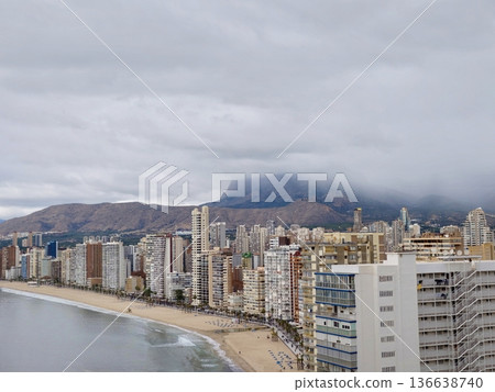Serene Coastal Landscape, Peaceful Shoreline Under Cloudy Sky With Empty Promenade And Distant Hills Serene Coastal Landscape, Peaceful Shoreline Under Cloudy Sky With Empty Promenade And Distant Hills 136638740