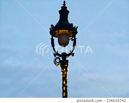 Elegant Night Illumination, Intricate Lamppost Illuminated With Gentle Amber Glow And Artistic Design Elegant Night Illumination, Intricate Lamppost Illuminated With Gentle Amber Glow And Artistic Design 136638742