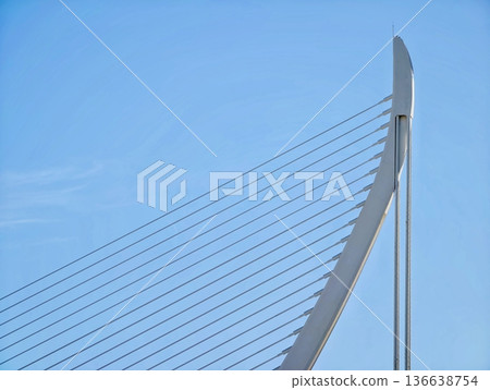 Innovative Bridge Pylon With Sleek Lines And Tensioned Supports Against Vibrant Sky Background Innovative Bridge Pylon With Sleek Lines And Tensioned Supports Against Vibrant Sky Background 136638754