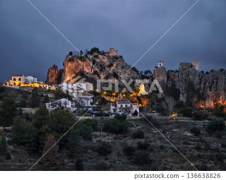 Silent Rural Hill Fortress Surrounded By Pines With Glowing Historic Structures Against Gloomy Sky 136638826