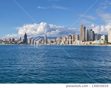Urban Coastal Vista, Harbor Area Showcases Mountain Backdrop And Modern Skyscrapers Alongside Rugged Cliffs Urban Coastal Vista, Harbor Area Showcases Mountain Backdrop And Modern Skyscrapers Alongside Rugged Cliffs 136638838