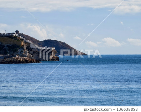 Ancient Fortress Situated On Cliffside Offering Breathtaking Views Of Ocean And Distant Harbor Ancient Fortress Situated On Cliffside Offering Breathtaking Views Of Ocean And Distant Harbor 136638858