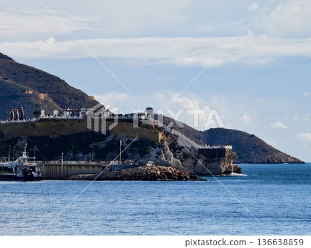 Cliffside Lighthouse Overlooking Vast Waters, Remote Lighthouse Standing On Rugged Headland With Seascape Cliffside Lighthouse Overlooking Vast Waters, Remote Lighthouse Standing On Rugged Headland With Seascape 136638859