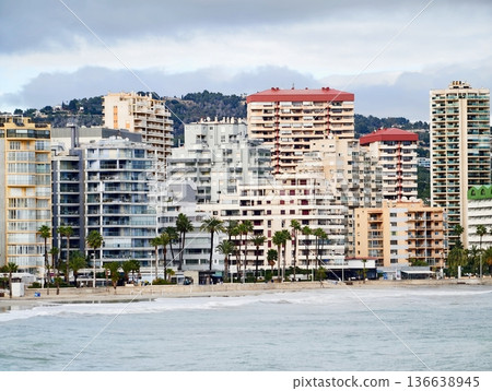 Modern Coastal Towers Overlooking Calm Waters, Sunny Seaside Skyline With Relaxing Holiday Atmosphere 136638945