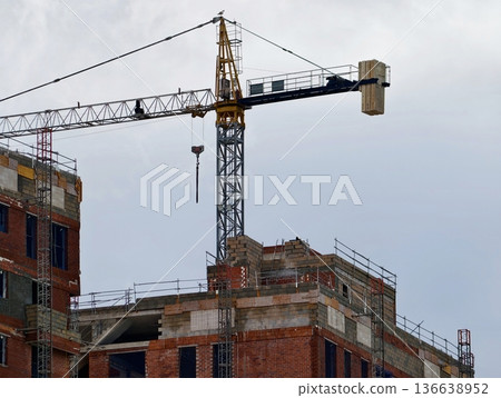 Active Construction With Scaffolding Detail, Facade Under Construction Showing Open Balconies And Beams 136638952