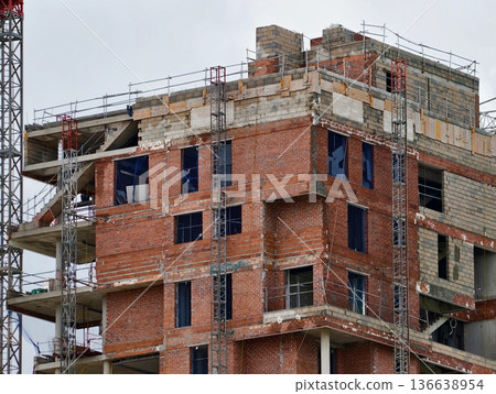 Urban Housing Under Construction, Partially Completed Apartment Complex With Open Windows And Balconies 136638954