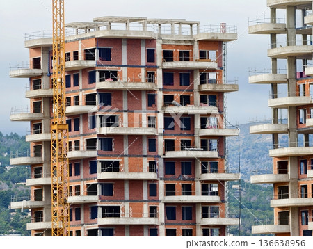 Massive Concrete Residential Blocks With Exposed Cores And Overhead Cranes Dominate Skyline 136638956