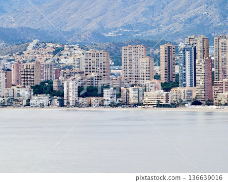 Dusk Over Gentle Mountain And City Views, Calm Seaside Scene With Layered Buildings And Pastel Skies 136639016