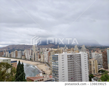 City Skyline View, Cityscape Along Water Displaying Mountain Silhouettes And Bustling Harbor Activity City Skyline View, Cityscape Along Water Displaying Mountain Silhouettes And Bustling Harbor Activity 136639025