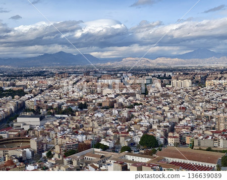 Serene City Environment During Evening Hours Featuring Layered Clouds And Distant Mountain Peaks 136639089