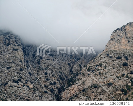 Enigmatic Landscape Where Fog Envelops Towering Summits And Verdant Valleys Spread Beneath 136639141