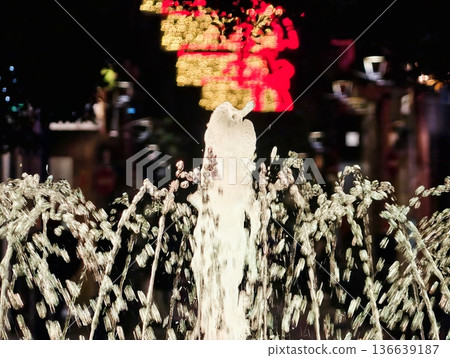 Illuminated Splash Creates Vivid Display, Central Water Jet Shines With Surrounding Arched Flow Patterns 136639187
