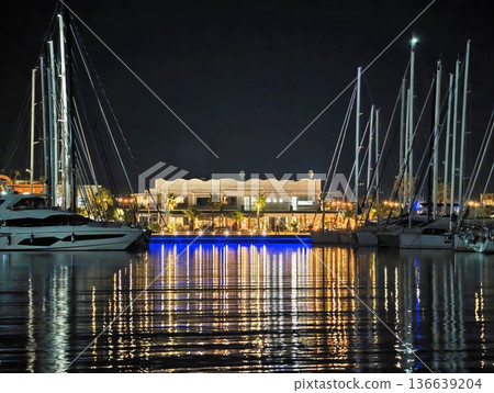 Serene Marina With Glowing Lights, Night Scene Of Tranquil Harbor With Illuminated Docks And Yachts 136639204