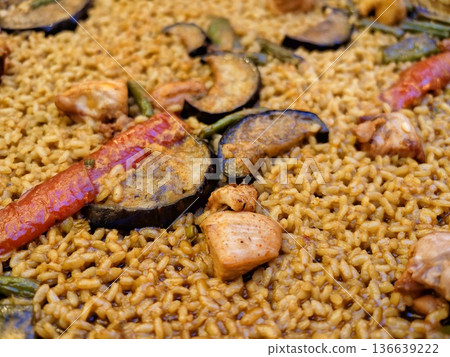 Beautifully Arranged Seafood And Vegetable Rice Dish With Golden Crust And Bright Lighting 136639222