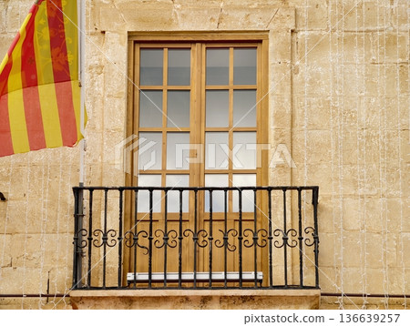 Historic Window Overlooking Festivities, Old Window With Decorative Iron Railings And Festive Atmosphere Historic Window Overlooking Festivities, Old Window With Decorative Iron Railings And Festive Atmosphere 136639257